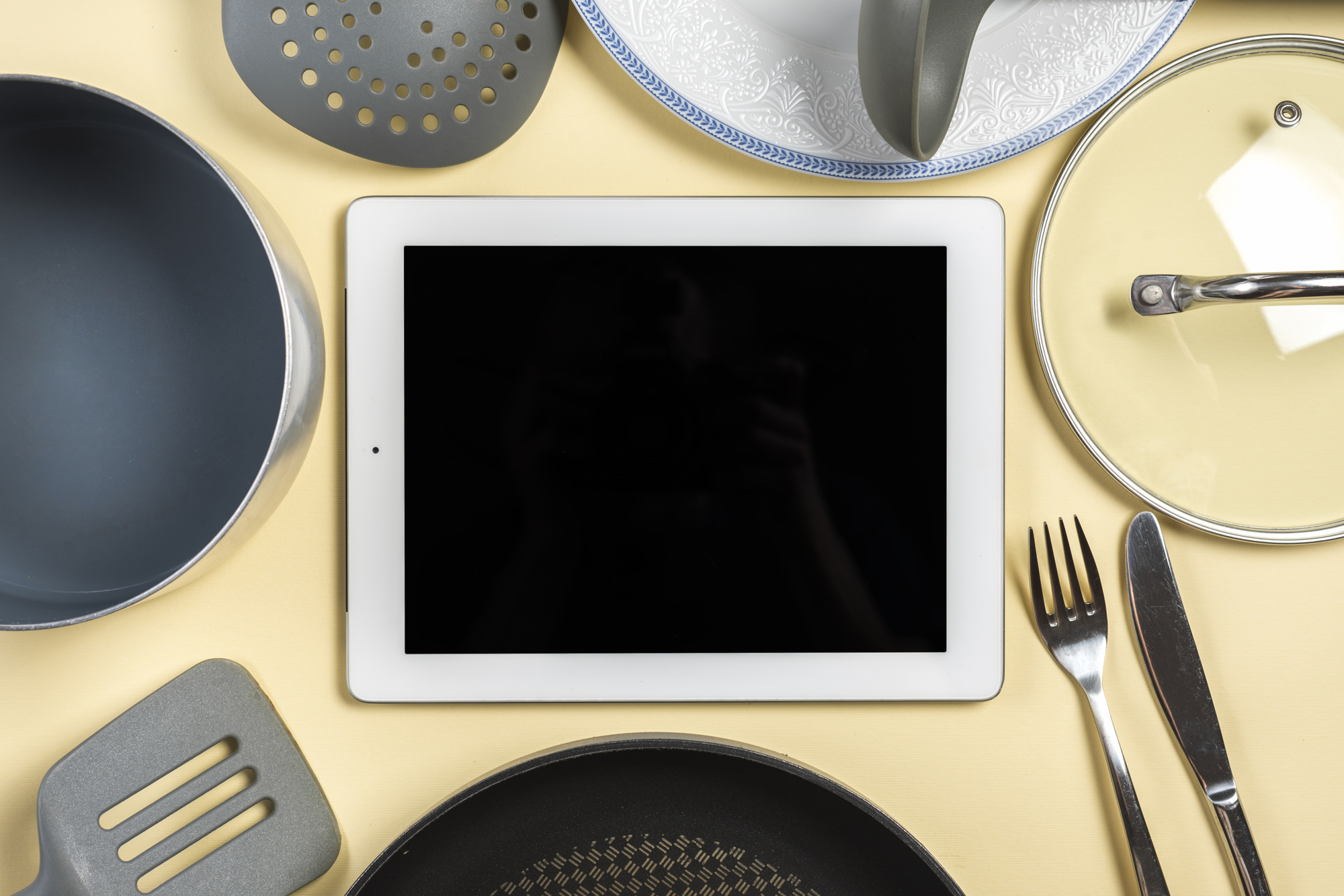 Workshop tools and plated dishes next to tablet
